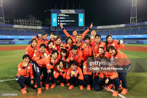 Team Japan poses for a team photo with their gold medals after defeating Team United States 2-0 in the Softball Gold Medal Game between Team Japan...