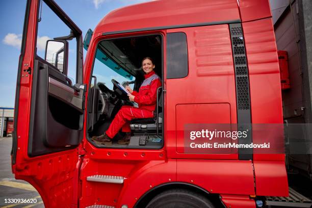 portrait of female truck driver doing paperwork - truck driver stock pictures, royalty-free photos & images