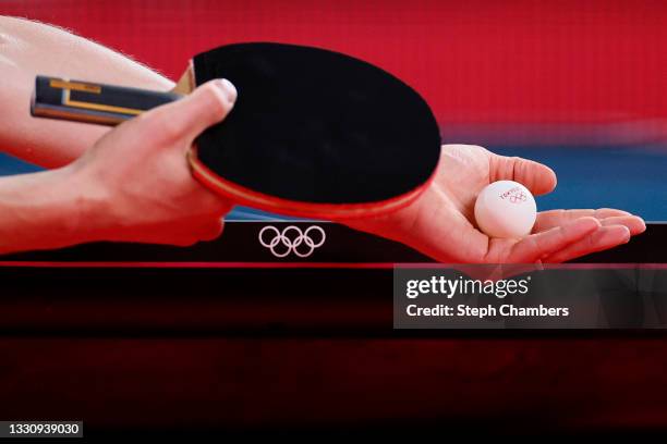 The table tennis ball rests in the hand of Timo Boll of Team Germany before a serve during his Men's Singles Round of 16 match on day four of the...