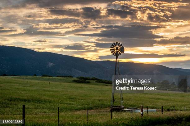 sunset behind windmill - colorado springs stockfoto's en -beelden