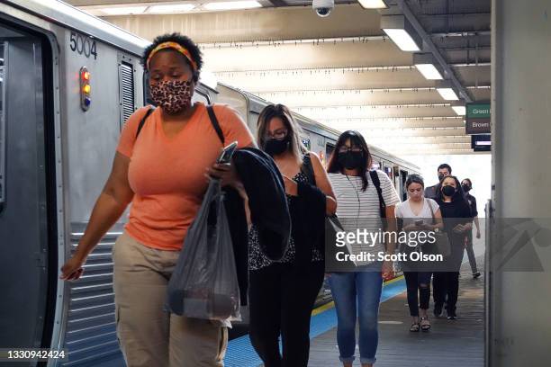 Commuters, most most of whom wear face masks, travel on the L train system in the Loop on July 27, 2021 in Chicago, Illinois. The Centers for Disease...