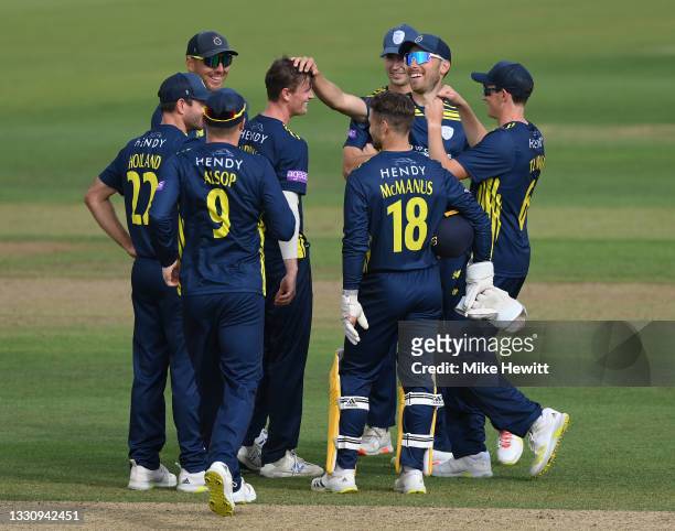 Nick Gubbins of Hampshire celebrates with team mates after dismissing Danial Ibrahim of Sussex for his fourth wicket following his century during the...