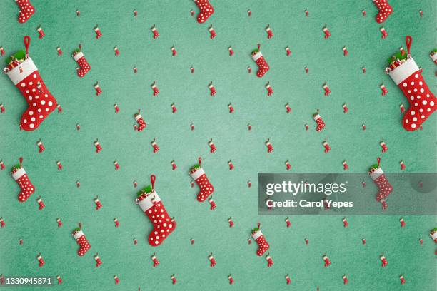 red christmas stocking pattern in green background - multi colored boot stock pictures, royalty-free photos & images