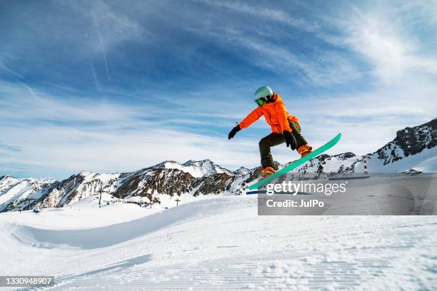 young woman snowboarding in mountains - snowboard jump bildbanksfoton och bilder