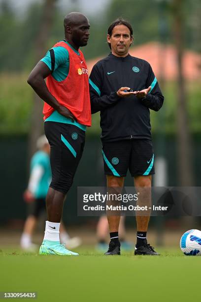 Romelu Lukaku of FC Internazionale speaks with Head Coach Simone Inzaghi of FC Internazionale during the FC Internazionale training session at the...