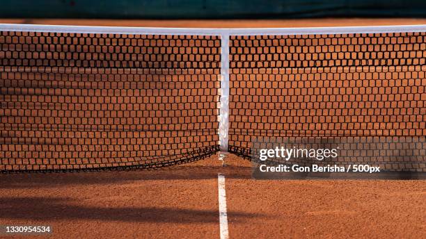 high angle view of net on tennis court - racquet stock pictures, royalty-free photos & images