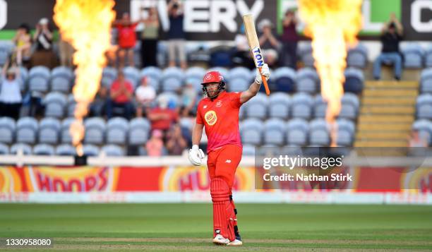 Jonny Bairstow of Welsh Fire raises his bat after scoring 50 runs during The Hundred match between Welsh Fire Men and Southern Brave Men at Sophia...