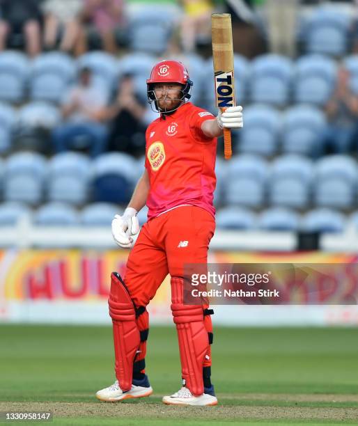 Jonny Bairstow of Welsh Fire raises his bat after scoring 50 runs during The Hundred match between Welsh Fire Men and Southern Brave Men at Sophia...