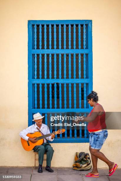 cuban busker playing guitar and a woman applauding in trinidad. cuba - cuban ethnicity stock pictures, royalty-free photos & images