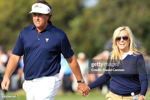 Phil Mickelson of the U.S. Team walks with wife Amy Mickelson during the Day One Foursome Matches of the 2011 Presidents Cup at Royal Melbourne Golf...