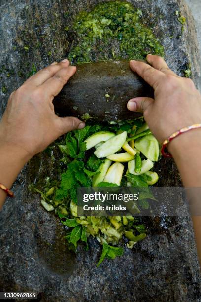 woman hands grinding herbs and spices on stone grinder - crushed leaves stock pictures, royalty-free photos & images