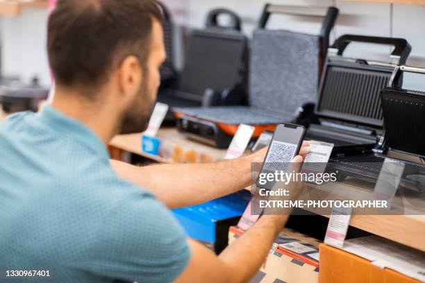 a man checking info about the toaster - customer experience stock pictures, royalty-free photos & images