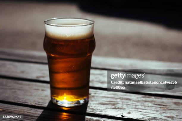 close-up of beer glass on table - beer close up stock pictures, royalty-free photos & images