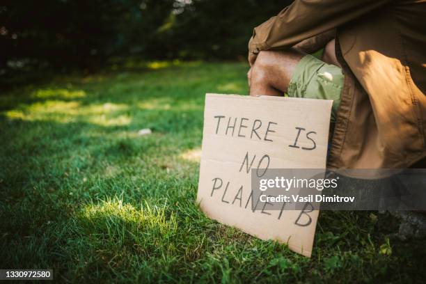 young activist / protester. environmental conservation / climate change protest. - climate change finance stock pictures, royalty-free photos & images