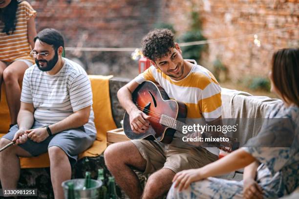 summer garden party - playing guitar stock pictures, royalty-free photos & images