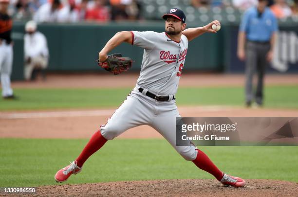 Brad Hand of the Washington Nationals pitches against the Baltimore Orioles at Oriole Park at Camden Yards on July 25, 2021 in Baltimore, Maryland.