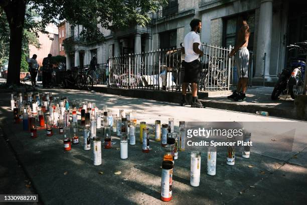 Candles mark the spot where Renaldo Joeseph was killed as residents and community activists gather in a Brooklyn neighborhood to remember the life of...