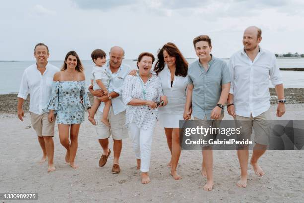 family meeting on the beach - uncle nephew stock pictures, royalty-free photos & images