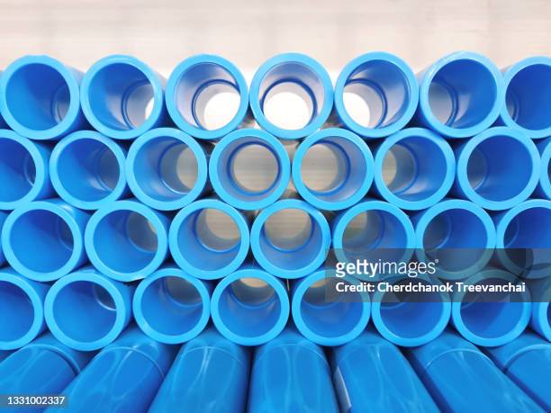 stack of blue color pvc pipe on the shelf - polimero foto e immagini stock