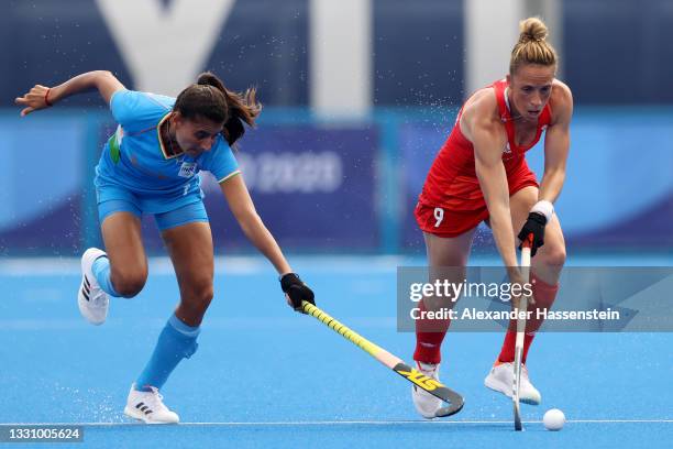 Sharmila Devi of Team India competes for the ball against Susannah Townsend of Team Great Britain during the Women's Preliminary Pool A match between...