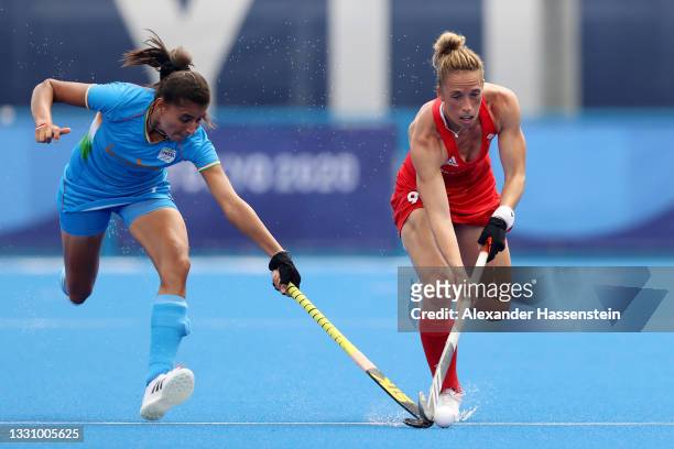 Sharmila Devi of Team India competes for the ball against Susannah Townsend of Team Great Britain during the Women's Preliminary Pool A match between...