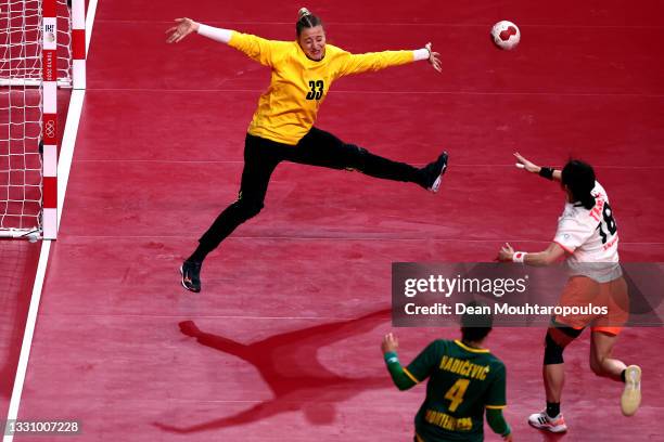 Anastasija Babovic of Team Montenegro prepares to save a shot at goal from Yuki Tanabe of Team Japan during the Woman's Preliminary Round Group A...