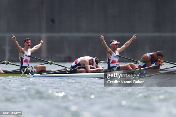 Angus Groom, Tom Barras and Jack Beaumont of Team Great Britain celebrate winning the silver medal during the Men's Quadruple Sculls Final A on day...