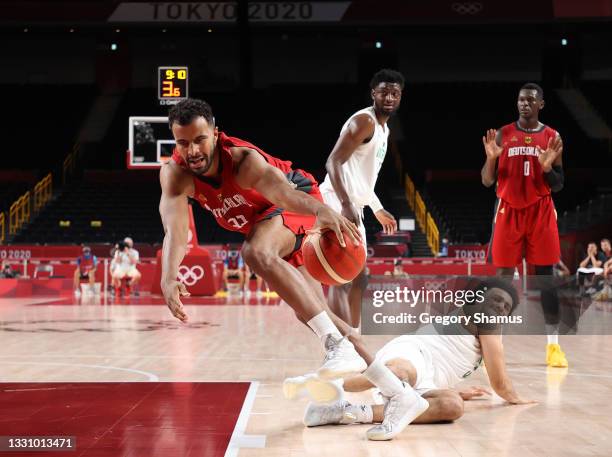 Johannes Thiemann of Team Germany drives to the basket against Jordan Nwora of Team Nigeria during the second half of a Men's Preliminary Round Group...