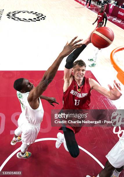 Moritz Wagner of Team Germany goes up for a shot against Chimezie Metu and Ekpe Udoh of Team Nigeria during the second half of a Men's Preliminary...