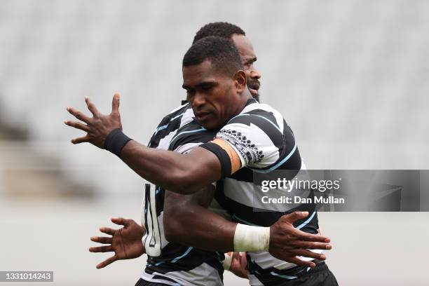 Semi Radradra of Team Fiji is congratulated by team mate Josua Vakurunabili after scoring a try during the Rugby Sevens Men's Semi-final match...