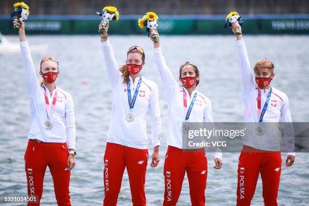 Silver medallists Agnieszka Kobus-Zawojska, Marta Wieliczko, Maria Sajdak and Katarzyna Zillmann of Team Poland celebrate on the podium after the...