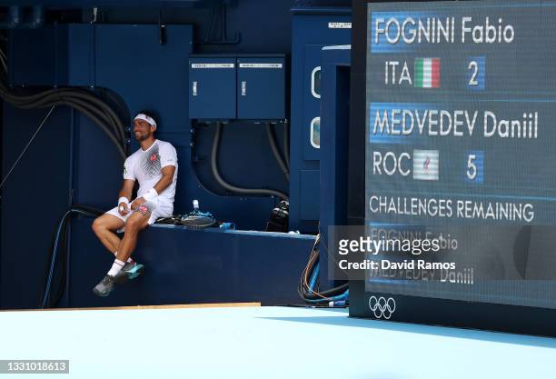 Fabio Fognini of Team Italy sits in the shade as his Daniil Medvedev of Team ROC receives medical attention during their Men's Singles Third Round...