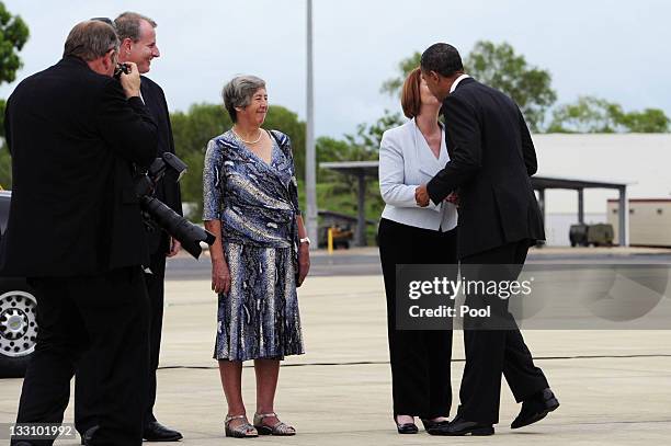 Australian Prime Minister Julia Gillard greets US President Barack Obama with a kiss next to Northern Territory Administrator Sally Thomas and Chief...