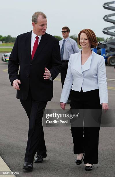 Australian Prime Minister Julia Gillard and Northern Territory Chief Minister Paul Henderson walk out onto the tarmac for the arrival of US President...