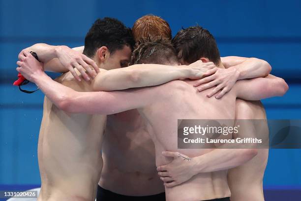 Tom Dean, James Guy, Matthew Richards and Duncan Scott of Team Great Britain react after competing in the Men's 4 x 200m Freestyle Relay Final on day...