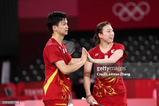 Yuta Watanabe and Arisa Higashino of Team Japan celebrate after their victory against Dechapol Puavaranukroh and Sapsiree Taerattanachai of Team...