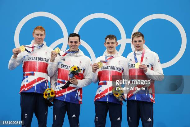 Tom Dean, James Guy, Matthew Richards and Duncan Scott of Team Great Britain pose with their gold medals during the medal ceremony for the Men's 4 x...