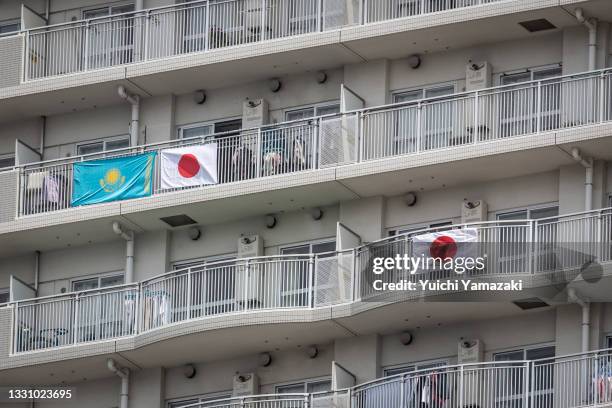 Japanese and Kazakhstan national flags are put on balconies of an apartment near the Odaiba Marine Park, Tokyo Olympics venue for Triathlon is seen...