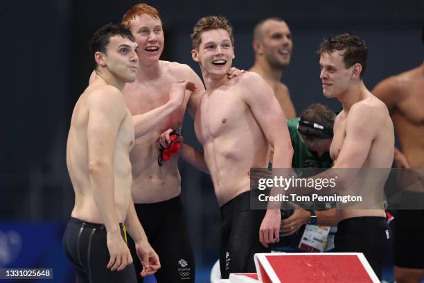 Tom Dean, James Guy, Matthew Richards and Duncan Scott of Team Great Britain react after competing in the Men's 4 x 200m Freestyle Relay Final on day...