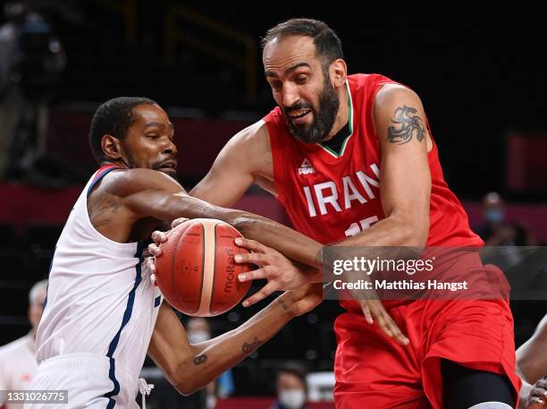 Hamed Haddadi of Team Iran and Kevin Durant of Team United States tangle during the first half of a Men's Preliminary Round Group A game on day five...