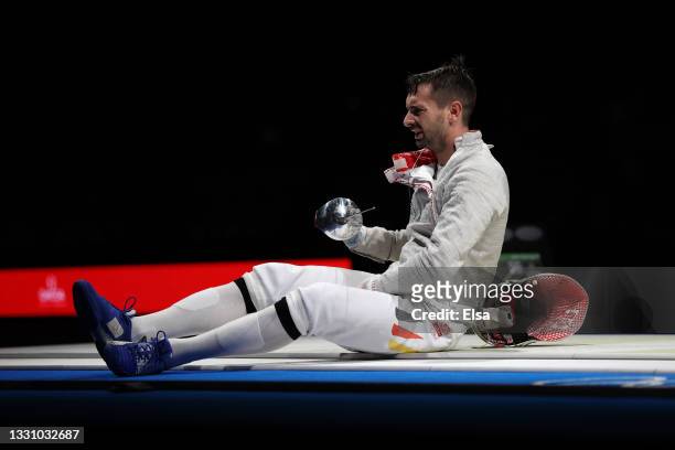 Matyas Szabo of Team Germany reacts to his injury during his match against Team South Korea in Men's Sabre Team on day five of the Tokyo 2020 Olympic...