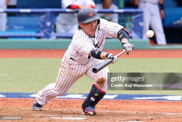 Takuya Kai of Team Japan lays down a sacrifice bunt in the ninth inning against Team Dominican Republic during the baseball opening round Group A...