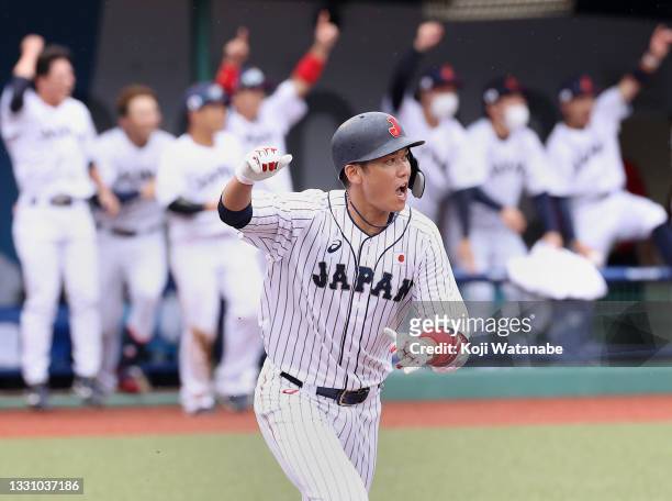 Hayato Sakamoto of Team Japan celebrates his walk-off single to center field to win 4-3 against Team Dominican Republic during the baseball opening...
