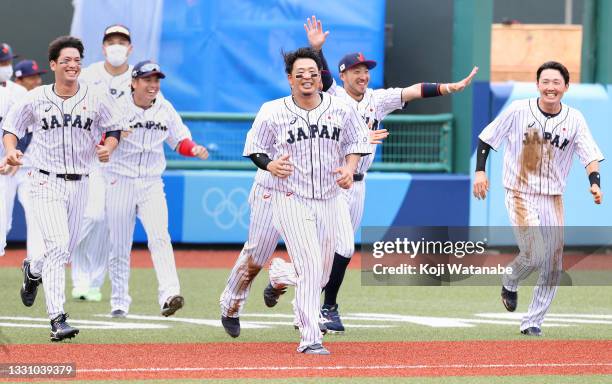 Team Japan run onto the field to celebrate after coming back to win the game in the ninth inning 4-3 against Team Dominican Republic during the...