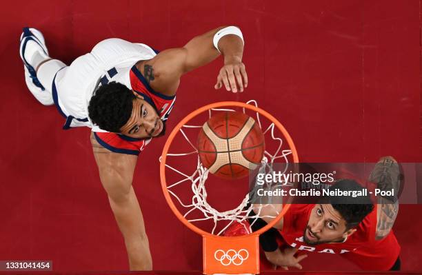 Jayson Tatum of Team United States and Mohammad Hassanzadeh of Team Iran eye the basket during a Men's Preliminary Round Group A game on day five of...