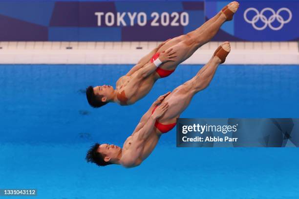 Wang Zongyuan and Siyi Xie of Team China compete during the Men's Synchronized 3 Meter Springboard Final on day five of the Tokyo 2020 Olympic Games...