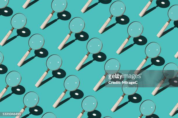magnifying glass focusing sunlight into a point - scrutiny stock pictures, royalty-free photos & images