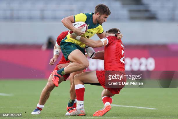 Josh Turner of Team Australia is tackled by Theo Sauder of Team Canada during the Rugby Sevens Men's Placing 7-8 match between Canada and Australia...
