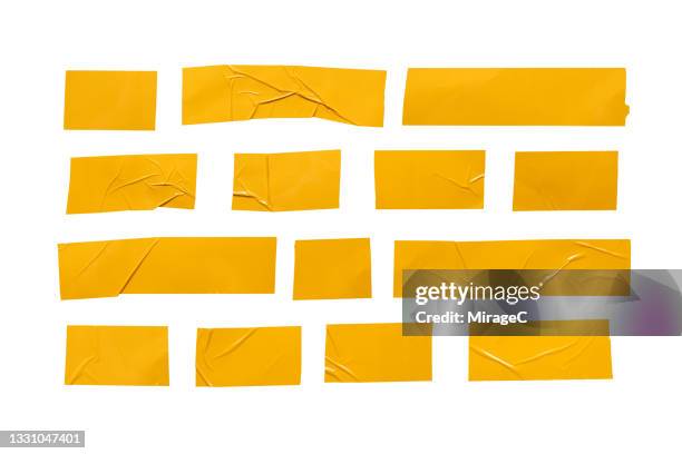 yellow plastic adhesive tape stripes - tape foto e immagini stock