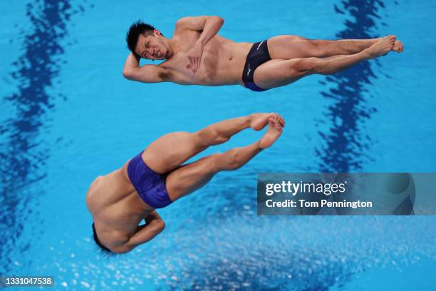 Sho Sakai and Ken Terauchi of Team Japan compete during the Men's Synchronised 3m Springboard final on day five of the Tokyo 2020 Olympic Games at...